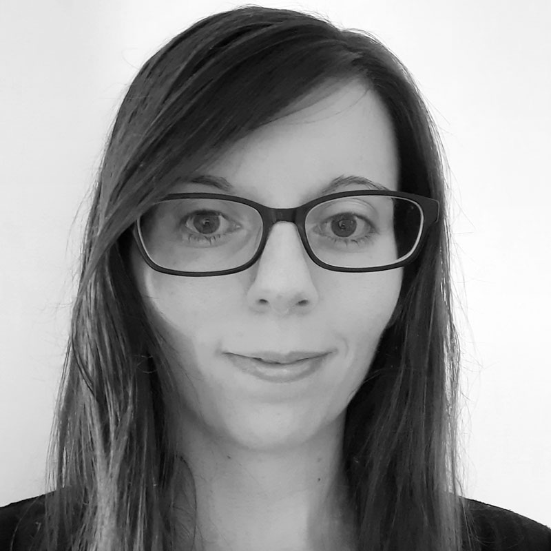 Black-and-white profile photograph of Christine wearing glasses